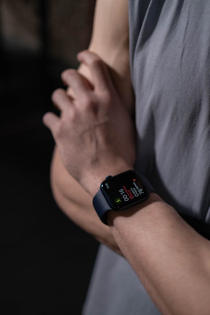 A close-up photo focusing on a person's arm wearing a smartwatch, highlighting modern technology.