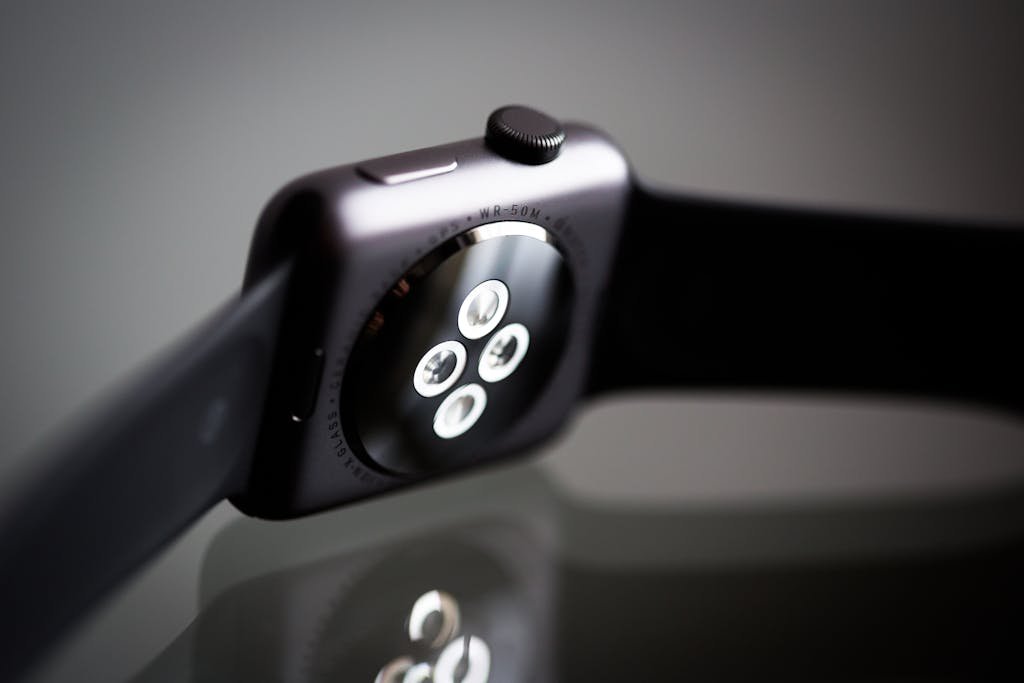 Detailed image of the back sensor of a modern smartwatch showing reflective surface and technology focus.